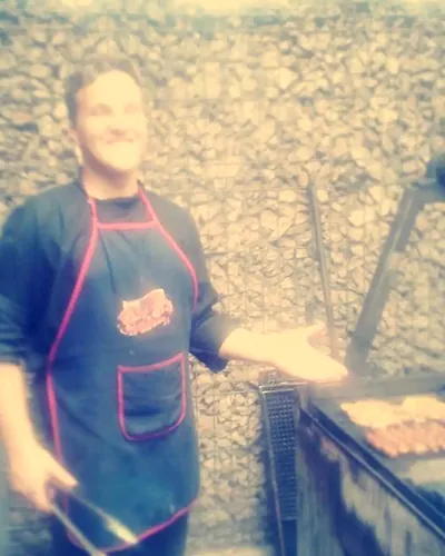 Ervin Csiki working the grill at Roata restaurant, Făget, 2014